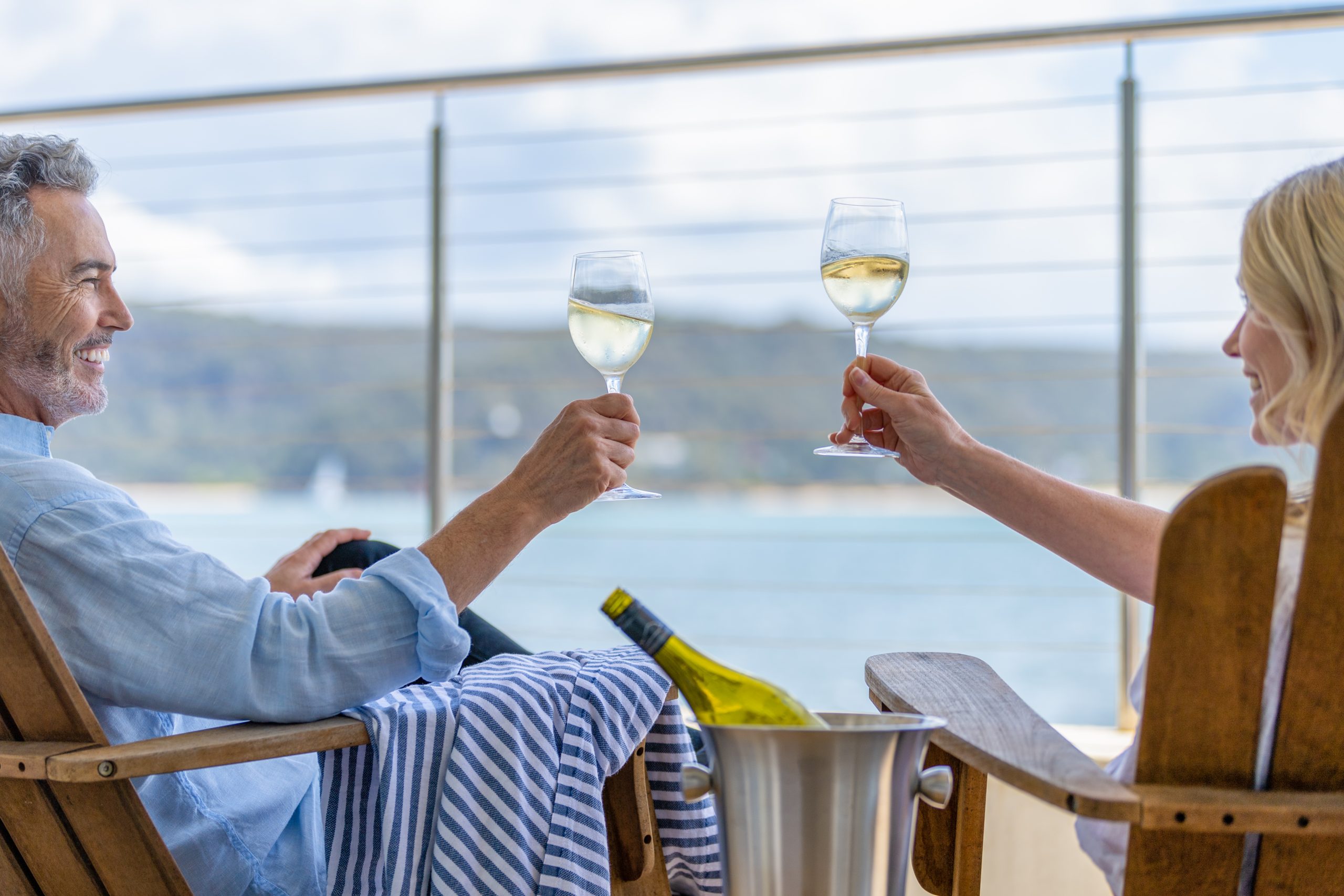Mature couple drinking wine out on the deck