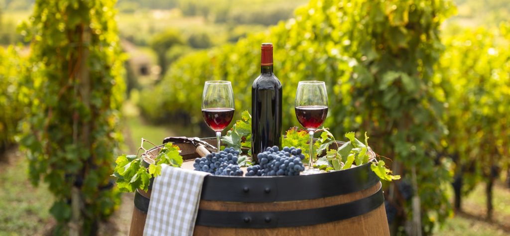 Red wine on barrel outdoor in Bordeaux Vineyard, France - A Way To Go Travel 