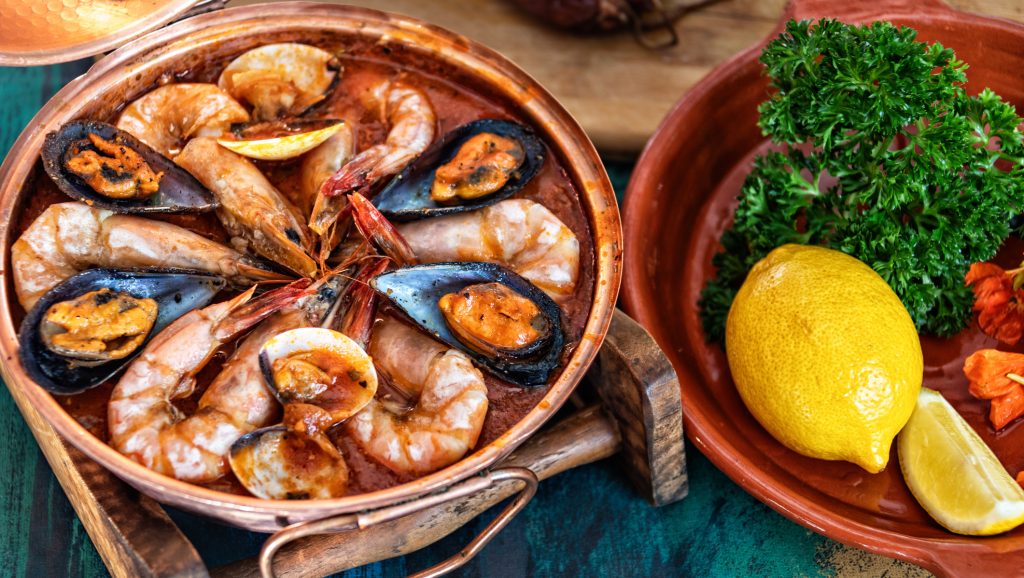 Traditional Portuguese ameijoas with clams served in a cataplana pot - A Way To Go Travel