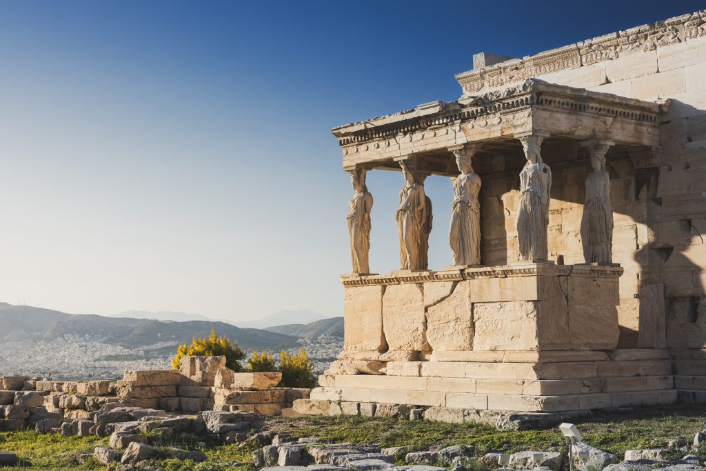 Cariatides Porch, Erechtheion on Acropolis of Athens against blue sky. Athens, Greece - A Way To Go Travel